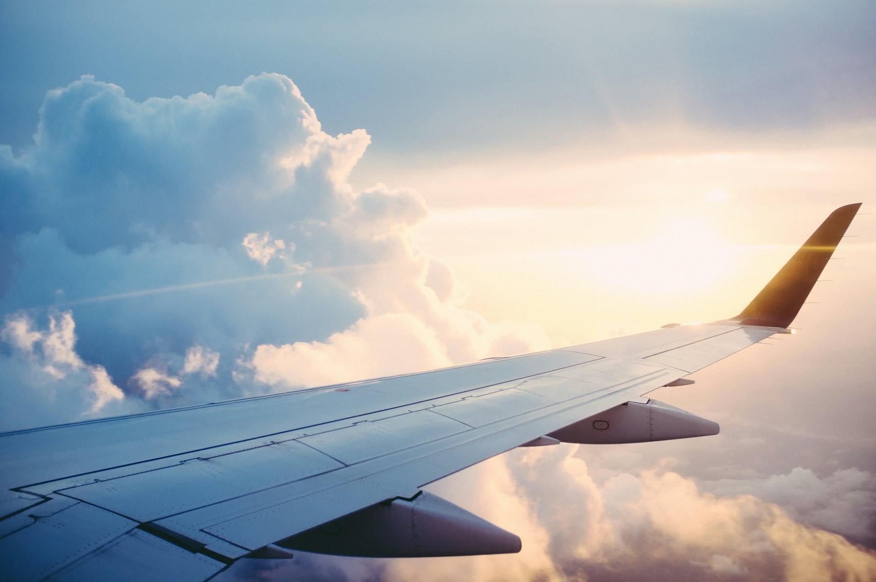 Aircraft wing above clouds